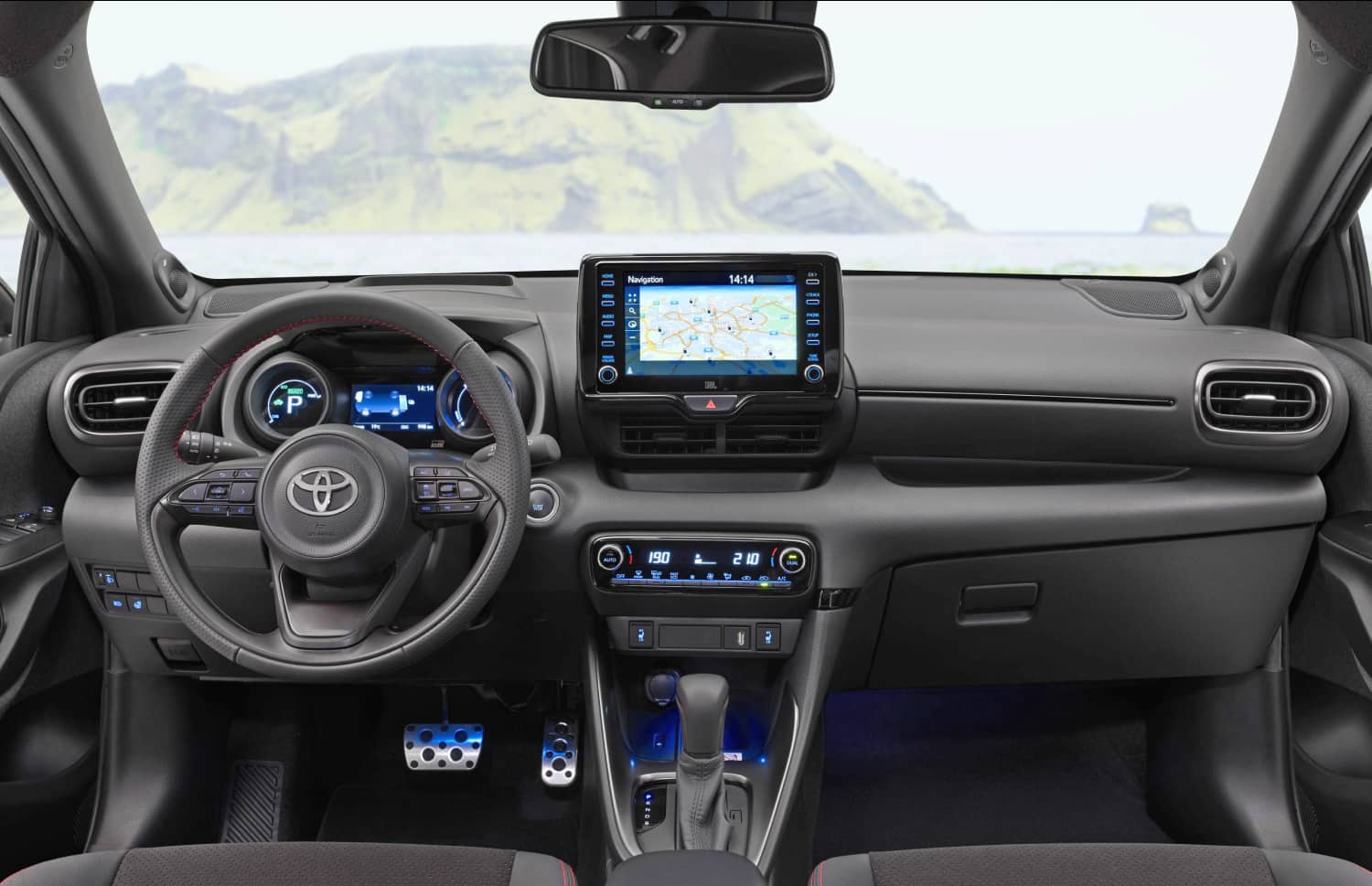 Toyota Yaris ibrida rossa con cambio automatico, 5 posti, GPS, retrocamera e spazio per 2 bagagli, ideale per viaggiare in Islanda.